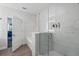 Elegant bathroom featuring a spacious shower with marble tile surround and glass enclosure at 14501 Grove Resort Ave # 2103, Winter Garden, FL 34787
