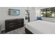 Well-appointed bedroom with a large window, TV, dresser, and comfortable bed at 14501 Grove Resort Ave # 2103, Winter Garden, FL 34787