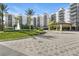 Beautiful condo building featuring covered entrance, fountain and lush landscaping at 14501 Grove Resort Ave # 2103, Winter Garden, FL 34787