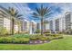 Beautifully landscaped exterior with a water fountain and manicured gardens at 14501 Grove Resort Ave # 2103, Winter Garden, FL 34787