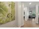 Inviting hallway featuring hardwood floors, stylish artwork, and a glimpse into the cozy living area, showcasing the home's modern design at 14501 Grove Resort Ave # 2103, Winter Garden, FL 34787
