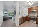 Modern kitchen with stainless steel appliances, wood cabinets, and an open layout that connects to the cozy living area at 14501 Grove Resort Ave # 2103, Winter Garden, FL 34787