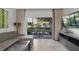Relaxing living area with a comfortable gray sofa, a modern coffee table, and a view of the outdoor greenery at 14501 Grove Resort Ave # 2103, Winter Garden, FL 34787