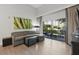 Inviting living area featuring a comfortable gray sofa, a sleek coffee table, and a serene view to the outdoor patio at 14501 Grove Resort Ave # 2103, Winter Garden, FL 34787