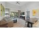 Comfortable living area with a gray sofa, dining table, and a view to the outdoor patio, perfect for relaxing and entertaining at 14501 Grove Resort Ave # 2103, Winter Garden, FL 34787