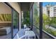 Relaxing screened-in patio offers outdoor seating with lush green garden views at 14501 Grove Resort Ave # 2103, Winter Garden, FL 34787