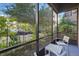 Relaxing screened-in patio offers outdoor seating with lush green garden views at 14501 Grove Resort Ave # 2103, Winter Garden, FL 34787