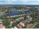 Overhead shot showcasing a community beside a lake, highlighting landscaped yards and recreational facilities at 1570 Westover Loop, Lake Mary, FL 32746