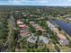 Overhead image of homes with private pools, showcasing mature trees and landscaped lawns along a tranquil road at 1570 Westover Loop, Lake Mary, FL 32746
