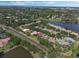 Aerial view of houses along a lakeside road, complete with lush trees and landscaping for a peaceful environment at 1570 Westover Loop, Lake Mary, FL 32746