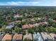 Wide aerial shot of a neighborhood with mature trees and lush landscaping near a small lake at 1570 Westover Loop, Lake Mary, FL 32746