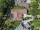 Aerial view showcasing a home with a tile roof and a screened-in pool in a lush neighborhood at 1570 Westover Loop, Lake Mary, FL 32746