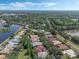 Scenic aerial view of a residential community next to a lake, featuring well-maintained homes and mature landscaping at 1570 Westover Loop, Lake Mary, FL 32746