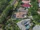 An aerial view showcasing the property with a pool, mature landscaping, and a barrel tile roof at 1570 Westover Loop, Lake Mary, FL 32746