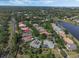 Aerial view featuring residences with pools along a scenic road by a lake, offering a blend of comfort and nature at 1570 Westover Loop, Lake Mary, FL 32746