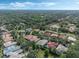 Expansive aerial view of a suburban neighborhood with lush greenery and mature trees, close to a serene lake at 1570 Westover Loop, Lake Mary, FL 32746