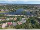 High-angle view of a residential area near a lake, showing a community pool and mature trees adding to the appeal at 1570 Westover Loop, Lake Mary, FL 32746