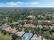 Overhead view of a residential area with well-maintained homes and mature trees surrounding a lake at 1570 Westover Loop, Lake Mary, FL 32746