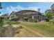 Expansive backyard featuring a screened pool area surrounded by lush landscaping at 1570 Westover Loop, Lake Mary, FL 32746