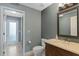 Bathroom with tile floors and vanity with unique frame on the mirror at 1570 Westover Loop, Lake Mary, FL 32746