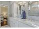 Elegant bathroom featuring a double sink vanity with marble countertops and decorative blue vases at 1570 Westover Loop, Lake Mary, FL 32746