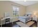 This bedroom features a white bed frame, a modern desk area, and a neutral color palette at 1570 Westover Loop, Lake Mary, FL 32746