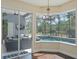 Breakfast nook with pool views, chandelier, and access to lanai with sliding glass doors at 1570 Westover Loop, Lake Mary, FL 32746