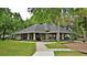 A picturesque clubhouse with well-maintained grounds and ample seating areas surrounded by trees at 1570 Westover Loop, Lake Mary, FL 32746