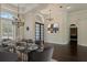 Elegant dining room features a modern table setting, stylish lighting, and dark hardwood floors at 1570 Westover Loop, Lake Mary, FL 32746