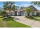 Charming home featuring a tile roof, a two-car garage, manicured landscaping, and a welcoming front entrance at 1570 Westover Loop, Lake Mary, FL 32746