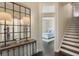 Hallway with stairs and a peek into a bedroom with a white bed frame at 1570 Westover Loop, Lake Mary, FL 32746