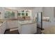 Modern kitchen with granite countertops, white cabinetry, and stainless steel appliances at 1570 Westover Loop, Lake Mary, FL 32746