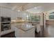 Bright kitchen features white cabinetry, granite counters, stainless appliances, and a central island at 1570 Westover Loop, Lake Mary, FL 32746