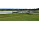 Lake view with a fishing pier featuring a scenic backdrop of lush greenery and a calm waterfront at 1570 Westover Loop, Lake Mary, FL 32746