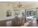Bright living room showcases fireplace, open kitchen, and direct access to screened-in lanai and pool at 1570 Westover Loop, Lake Mary, FL 32746
