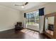 This living room has hardwood floors, a large window, and a dark chair at 1570 Westover Loop, Lake Mary, FL 32746