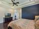 Spacious primary bedroom featuring dark wood floors, recessed lighting, and a large TV at 1570 Westover Loop, Lake Mary, FL 32746
