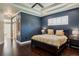 This main bedroom has a trey ceiling, dark blue walls, hardwood floors and a bathroom attached at 1570 Westover Loop, Lake Mary, FL 32746