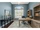 Office space with built-in shelving, an oversized window, and hardwood floors at 1570 Westover Loop, Lake Mary, FL 32746
