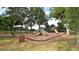 Community playground with multiple play structures, slides, and benches under mature shade trees at 1570 Westover Loop, Lake Mary, FL 32746