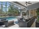 Enclosed backyard pool area with a cozy seating area perfect for entertaining at 1570 Westover Loop, Lake Mary, FL 32746