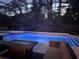 Covered backyard pool and hot tub area with outdoor seating and a fire pit at 1570 Westover Loop, Lake Mary, FL 32746