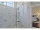 Modern shower with white marble tiling, glass door, and built-in shelving niche at 1570 Westover Loop, Lake Mary, FL 32746