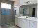 Stylish bathroom with a frameless shower, quartz vanity, tile flooring, and modern finishes at 16759 Muskgrass Dr, Winter Garden, FL 34787