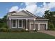 Charming single-Gathering home with a manicured lawn, gray stucco exterior, and a two-car garage in a residential neighborhood at 16759 Muskgrass Dr, Winter Garden, FL 34787