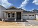 Charming single-story home featuring a two-car garage and craftsman details including brick trim and a covered entry at 16759 Muskgrass Dr, Winter Garden, FL 34787