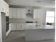 Bright kitchen featuring a large island, stainless steel appliances, white cabinets, and modern backsplash at 16759 Muskgrass Dr, Winter Garden, FL 34787