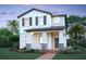 Charming two-story home with a welcoming front porch and stone accents, complemented by a beautifully landscaped yard at 17353 Beachgrass Aly, Winter Garden, FL 34787