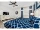Well-decorated bedroom featuring a geometrically patterned blue comforter and matching curtains at 1781 Sawyer Palm Pl, Kissimmee, FL 34747
