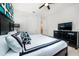 Stylish bedroom with a black dresser and large television for entertainment at 1781 Sawyer Palm Pl, Kissimmee, FL 34747
